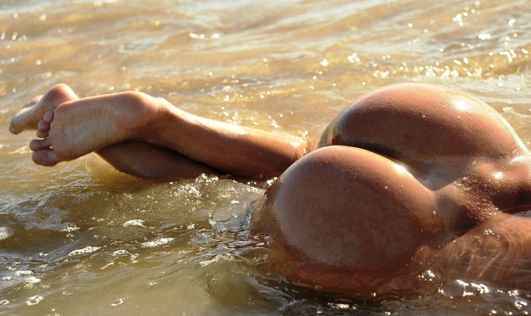 Naked female priests in the sand