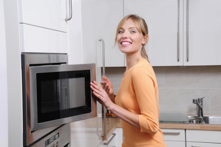 A woman with a microwave