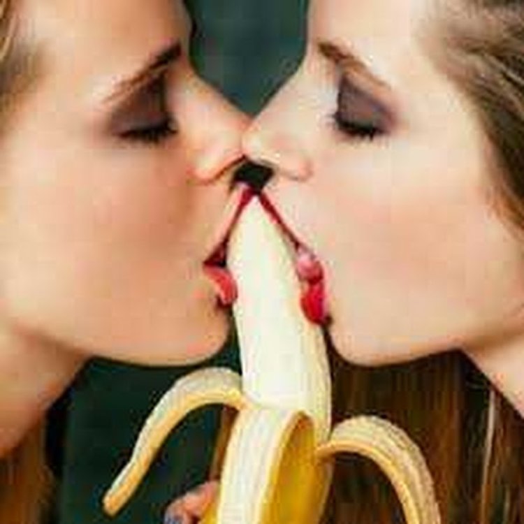 The girl licks the banana