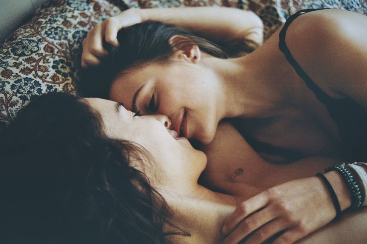 Kisses of two girls in bed