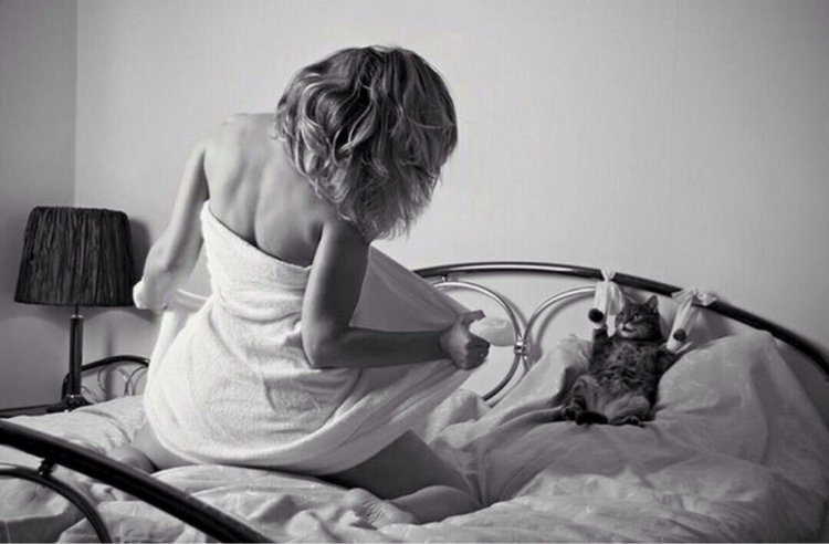 Girl with a cat on the bed